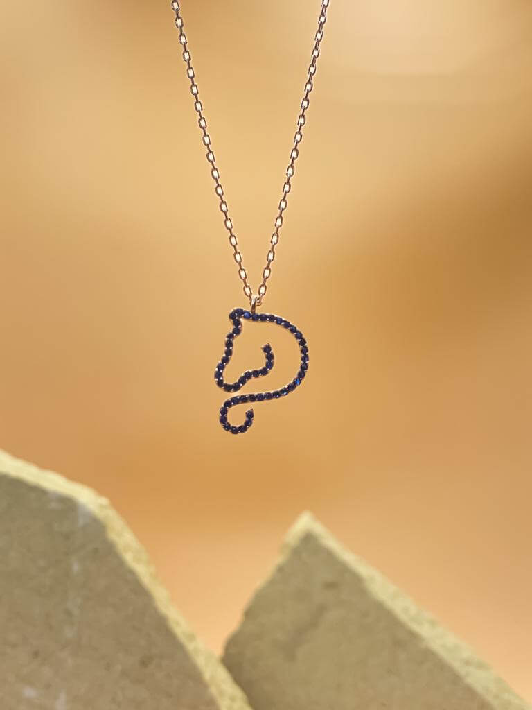 Equine Elegance Necklace featuring zircon stones in a horse silhouette on a silver chain background