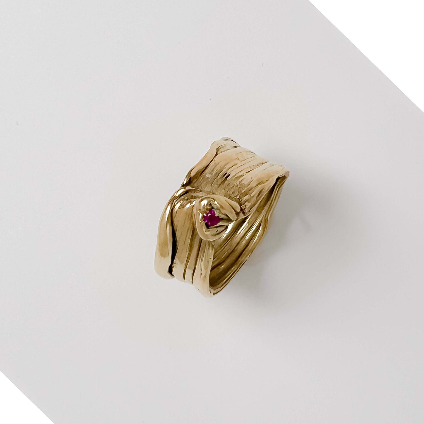 Handcrafted bronze Mitsuro Hikimi ring with sparkling Zircon stone on white background