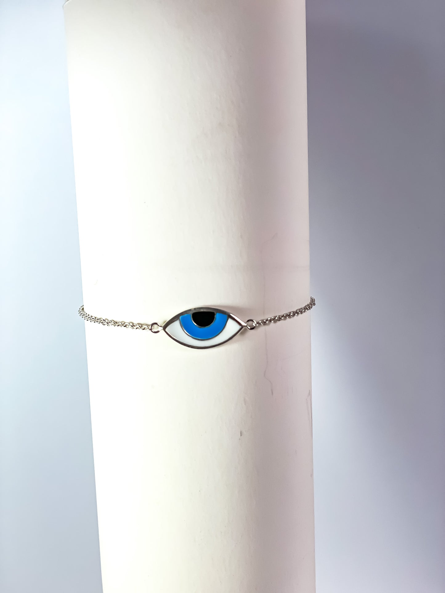 Silver evil eye bracelet for protection and style against negative energies.